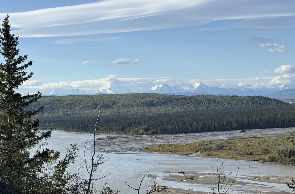 mountins in the background of a picture of a river